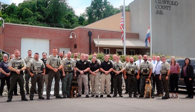 staff photo in front of the crawford county jail